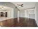 Open-concept living room with a vaulted ceiling, ceiling fan, and dark wood flooring at 1542 Bogota Way, Jonesboro, GA 30236