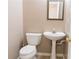 This half bathroom features a white pedestal sink at 3045 Arden Ridge Dr, Suwanee, GA 30024