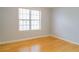 A sunlit bedroom with bamboo floors and a large window offering ample light at 3045 Arden Ridge Dr, Suwanee, GA 30024