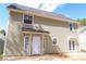 Back of home featuring neutral siding, a small patio, and double french doors at 3045 Arden Ridge Dr, Suwanee, GA 30024