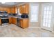 Modern kitchen featuring stainless steel appliances, granite countertops, and light wood cabinets at 3045 Arden Ridge Dr, Suwanee, GA 30024