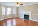 Cozy living room with hardwood floors, complemented by a fireplace and bay windows for ample light at 3045 Arden Ridge Dr, Suwanee, GA 30024