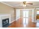 Warm living area featuring hardwood floors, a fireplace, and French doors leading to the backyard at 3045 Arden Ridge Dr, Suwanee, GA 30024