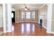 Spacious living room with hardwood floors, a fireplace, and large windows bringing in natural light at 3045 Arden Ridge Dr, Suwanee, GA 30024