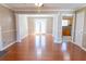 Bright living area featuring hardwood floors, white columns, and French doors leading to the backyard at 3045 Arden Ridge Dr, Suwanee, GA 30024