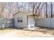 Storage shed featuring white painted siding, a small window, and double doors at 3045 Arden Ridge Dr, Suwanee, GA 30024