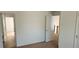 A bedroom featuring neutral carpet, white walls, and access to other rooms at 3512 Clear Creek Crossing, Kennesaw, GA 30144