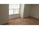 A standard bedroom featuring wall-to-wall neutral carpet and a double-paned window at 3512 Clear Creek Crossing, Kennesaw, GA 30144