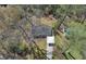 Aerial view of house featuring a carport nestled among trees, with a unique design at 629 Moselle Sw Dr, Mableton, GA 30126