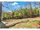 Expansive backyard featuring lush greenery and mature trees, perfect for outdoor activities at 629 Moselle Sw Dr, Mableton, GA 30126