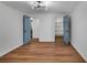 Bedroom with hardwood floors and a modern light fixture featuring painted doors and a closet at 629 Moselle Sw Dr, Mableton, GA 30126