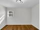 Empty bedroom featuring hardwood floors, white walls, and one window for natural light at 629 Moselle Sw Dr, Mableton, GA 30126