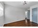 Hardwood floors complement this airy bedroom featuring a blue accent door and bright natural lighting at 629 Moselle Sw Dr, Mableton, GA 30126