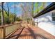 Outdoor deck with railing overlooking a lush wooded area, connected to white brick house at 629 Moselle Sw Dr, Mableton, GA 30126