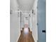 Hallway with hardwood floors leading to a sunlit room, painted in bright neutral colors at 629 Moselle Sw Dr, Mableton, GA 30126