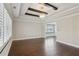 Open living room boasting hardwood floors, window with shutters, and an ornate ceiling with decorative beams at 2810 Briarcliff Ne Rd, Atlanta, GA 30329