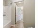 Bathroom with a white shower/tub combination and view into the vanity area at 3255 Blackburn Dr, Cumming, GA 30040