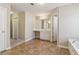 Bathroom with vanity and sink, tile flooring, and a view of the bathtub at 3255 Blackburn Dr, Cumming, GA 30040