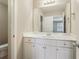 Bathroom vanity with white cabinets, quartz countertop, and large mirror at 3255 Blackburn Dr, Cumming, GA 30040