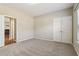 Spacious bedroom featuring neutral carpet and an ensuite bathroom entrance at 3255 Blackburn Dr, Cumming, GA 30040