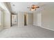 This spacious bedroom features plush gray carpeting, a ceiling fan, and multiple doors at 3255 Blackburn Dr, Cumming, GA 30040