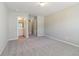 Spacious bedroom with plush gray carpeting and neutral paint, adjacent to a bathroom and hallway at 3255 Blackburn Dr, Cumming, GA 30040