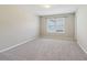 Bright, carpeted bedroom featuring a window with blinds for ample natural light at 3255 Blackburn Dr, Cumming, GA 30040
