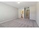 Spacious bedroom with plush carpet and an open doorway to the bathroom at 3255 Blackburn Dr, Cumming, GA 30040