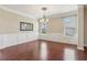 Dining room has a chandelier, hardwood floors, large windows, and wainscoting at 3255 Blackburn Dr, Cumming, GA 30040