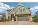 Charming two-story home with green siding, stone accents, and a well-manicured front yard at 3255 Blackburn Dr, Cumming, GA 30040