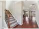 Spacious foyer with hardwood floors, carpeted staircase, and view into an open floorplan at 3255 Blackburn Dr, Cumming, GA 30040