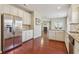 Open concept kitchen with stainless steel appliances and white cabinets at 3255 Blackburn Dr, Cumming, GA 30040