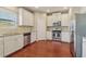 Kitchen with stainless appliances, white cabinets, and granite counter tops at 3255 Blackburn Dr, Cumming, GA 30040