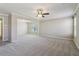 Open living room with neutral carpet, a ceiling fan, and bright natural light at 3255 Blackburn Dr, Cumming, GA 30040