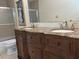 Dual-sink bathroom vanity with brown marble countertop and decorative wood cabinetry at 2894 Dellinger Dr, Marietta, GA 30062