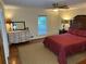 A well-lit bedroom features a large bed, two nightstands, a dresser, and a window with natural light at 2894 Dellinger Dr, Marietta, GA 30062