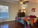 Bright bedroom with hardwood floors, large window, and colorful bedspread at 2894 Dellinger Dr, Marietta, GA 30062
