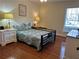 Bedroom featuring a bed with patterned linens, hardwood floors, and a bright window at 2894 Dellinger Dr, Marietta, GA 30062