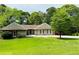 Charming single-story home with a well-manicured lawn and mature trees at 2894 Dellinger Dr, Marietta, GA 30062