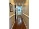 Hallway featuring hardwood floors, neutral walls, and elegant trim details at 2894 Dellinger Dr, Marietta, GA 30062
