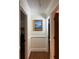 Hallway featuring hardwood floors, white molding and decorative artwork at 2894 Dellinger Dr, Marietta, GA 30062