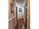 Hallway featuring hardwood floors, white molding and decorative artwork at 2894 Dellinger Dr, Marietta, GA 30062