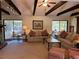 Inviting living room with beamed ceilings and screened in porch access on either side at 2894 Dellinger Dr, Marietta, GA 30062