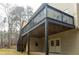 Exterior of house featuring a dark back deck with stairs at 5150 Rockford Ln, Stockbridge, GA 30281