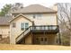 Back exterior featuring a covered patio, stairs, and beautiful backyard at 5150 Rockford Ln, Stockbridge, GA 30281