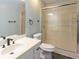 Bright bathroom featuring shower with sliding glass doors, dark fixtures, and neutral colored walls at 5150 Rockford Ln, Stockbridge, GA 30281