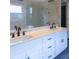 Bathroom showcasing double sinks, quartz countertops, shaker cabinets, and a glass-enclosed shower at 5150 Rockford Ln, Stockbridge, GA 30281