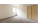 Bedroom with natural light, plush carpet, neutral walls, and bi-fold closet doors at 5150 Rockford Ln, Stockbridge, GA 30281