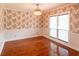 Empty dining room with hardwood floors, chandelier, and window with blinds at 5150 Rockford Ln, Stockbridge, GA 30281