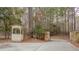 Stone and wrought iron entry gate with guard house on a wooded property at 5150 Rockford Ln, Stockbridge, GA 30281